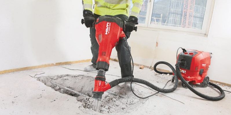 TE 2000-AVR concrete demolition hammer being used with a dust removal system and vacuum cleaner for virtually dust-free chiseling / breaking