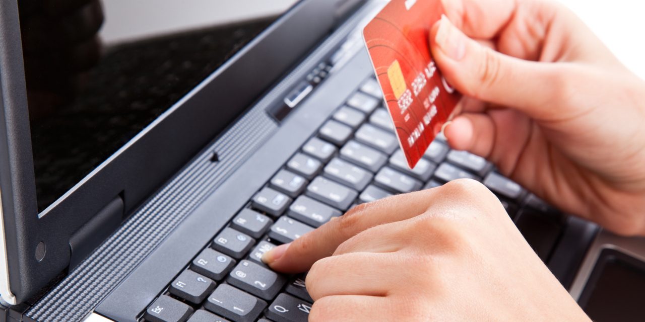 Credit card in hand for buying online