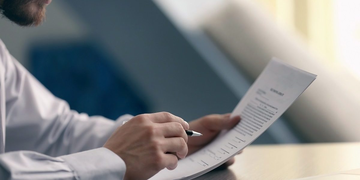 Businessman reading documents; Shutterstock ID 543880450; PO: blog